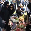 Bunga Zainal menaburkan bunga di makam ayah