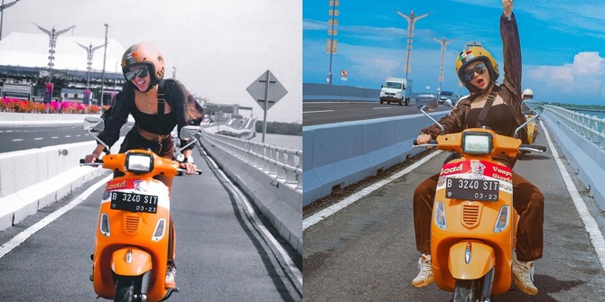 Photo of Wika Salim Riding a Vespa, Hot in a Crop Top and Showing Off Standing While Driving