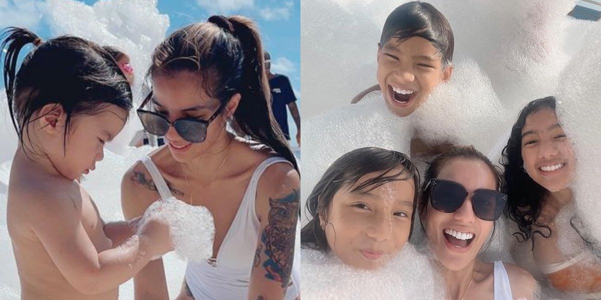 Portrait of Sheila Marcia Looking Beautiful in a Swimsuit, Bathing with Foam While Caring for Her Child