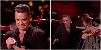 Kejadian Robbie Williams Pakai Hand Sanitizer Setelah Pegang Fans