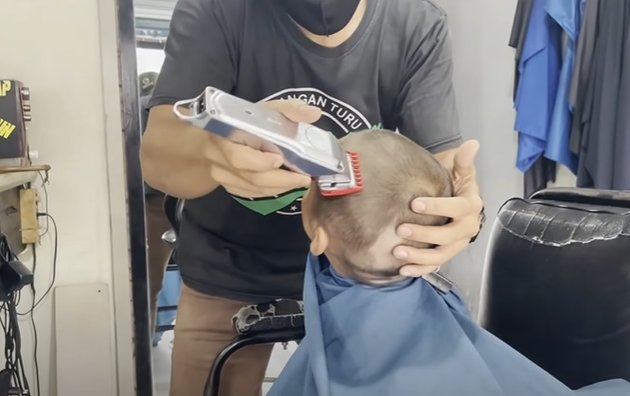 Known as the Sultan's Child, Portrait of Kiano, Baim Wong's Son, Getting a Haircut at the Barber