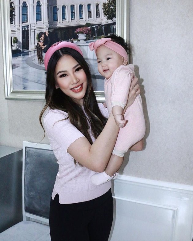 Portrait of Kezia Toemion Twinning with Kelly The Princess, Hot Mom and Cute Baby in Branded Clothes