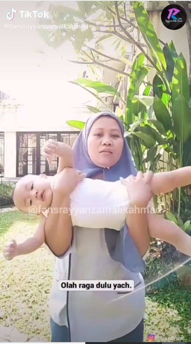 A Snapshot of Rayyanza Being Carried Like a Dumbbell by Nurse Rini, Laughing - His Expression is So Adorable