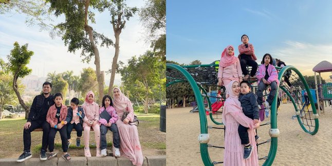 Portrait of Oki Setiana Dewi Inviting Children to Play in Cairo City Park, Coordinated in Pink Outfits