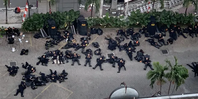 Potret Polisi Kelelahan & Tidur di Atas Aspal Ini Bikin Haru Netizen