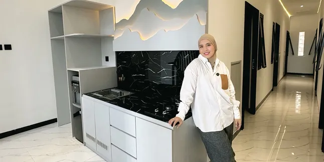 Portrait of Tya Ariestya Showcasing Her New Kos Kitchen, Luxurious Yet Economical